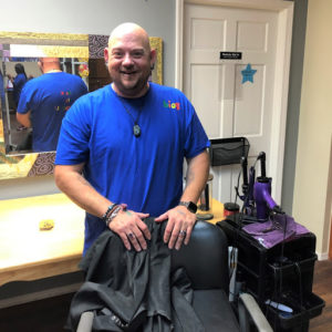 Sam Markcum, part-time direct support professional, with barber chair