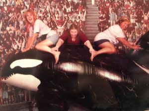 Melissa, Cathy, and Susan posing on an Orca statue