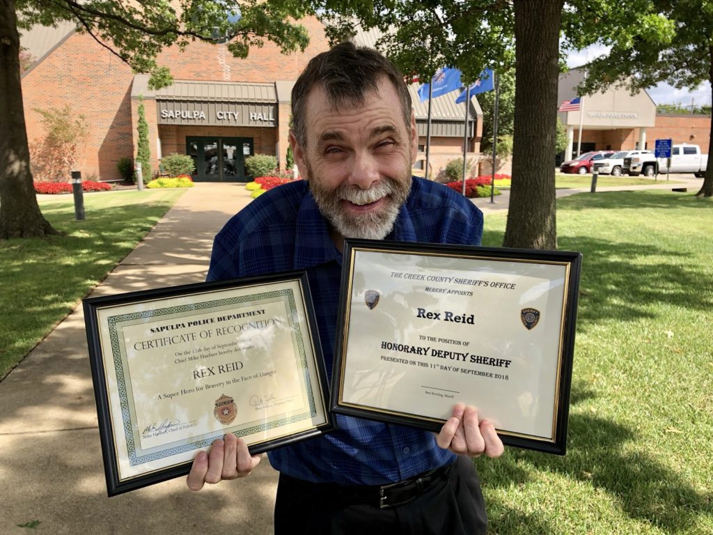 Rex receives certificates from the Oklahoma Police Department
